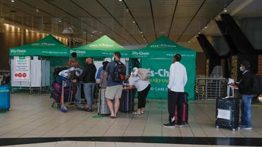 Travellers queue at an area for polymerase chain reaction (PCR) Covid-19 tests at OR Tambo International Airport in Johannesburg on November 27, 2021. (AFP)