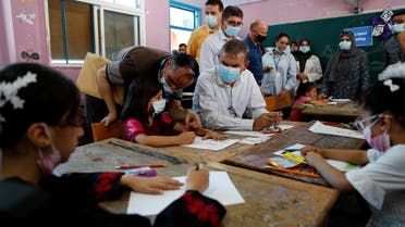 UNRWA chief Philippe Lazzarini sits with students participating in an UNRWA summer camp at Beach Preparatory School for girls, in the Shati refugee camp. (File Photo: AP)