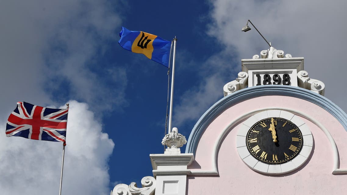 The British Union flag and the national flag of Barbados fly next to each other on a building as preparations take place to mark the Caribbean island's transition to a republic, in Bridgetown, Barbados, November 29, 2021. (Reuters)