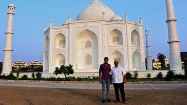 In this photograph taken on November 25, 2021, Indian businessman Anand Prakash Chouksey (R) and his son Kabir pose in front of a replica of the Taj Mahal at Burhanpur in India’s Madhya Pradesh state. (Uma Shankar Mishra/AFP)