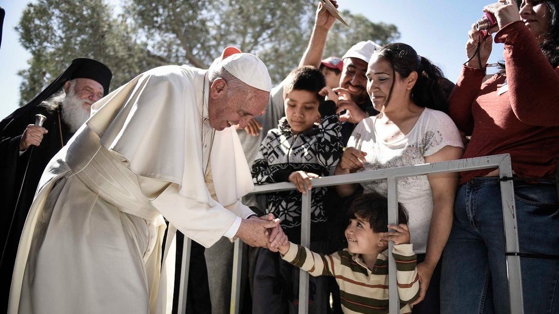 In this file handout photograph taken on April 16, 2016, Pope Francis greets a child during his visit to the Moria detention center for migrants and refugees near Mytilene on the Greek island of Lesbos. (Photo by Prime Minister’s Office/AFP)