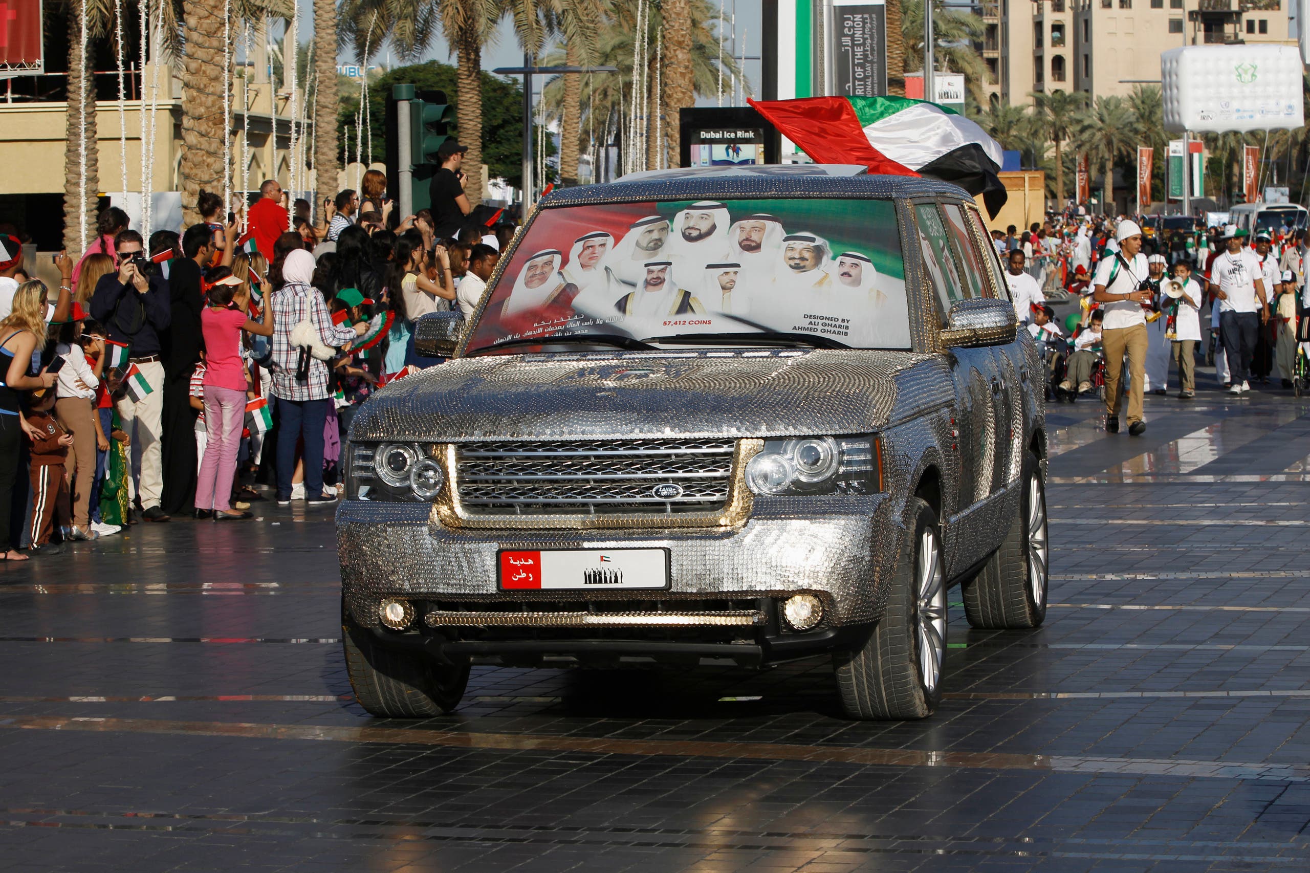 Pictures of President Khalifa and PM Sheikh Mohammed are printed on windscreen of car during parade celebrating 41st National Day of the United Arab Emirates, in Dubai. (Reuters)