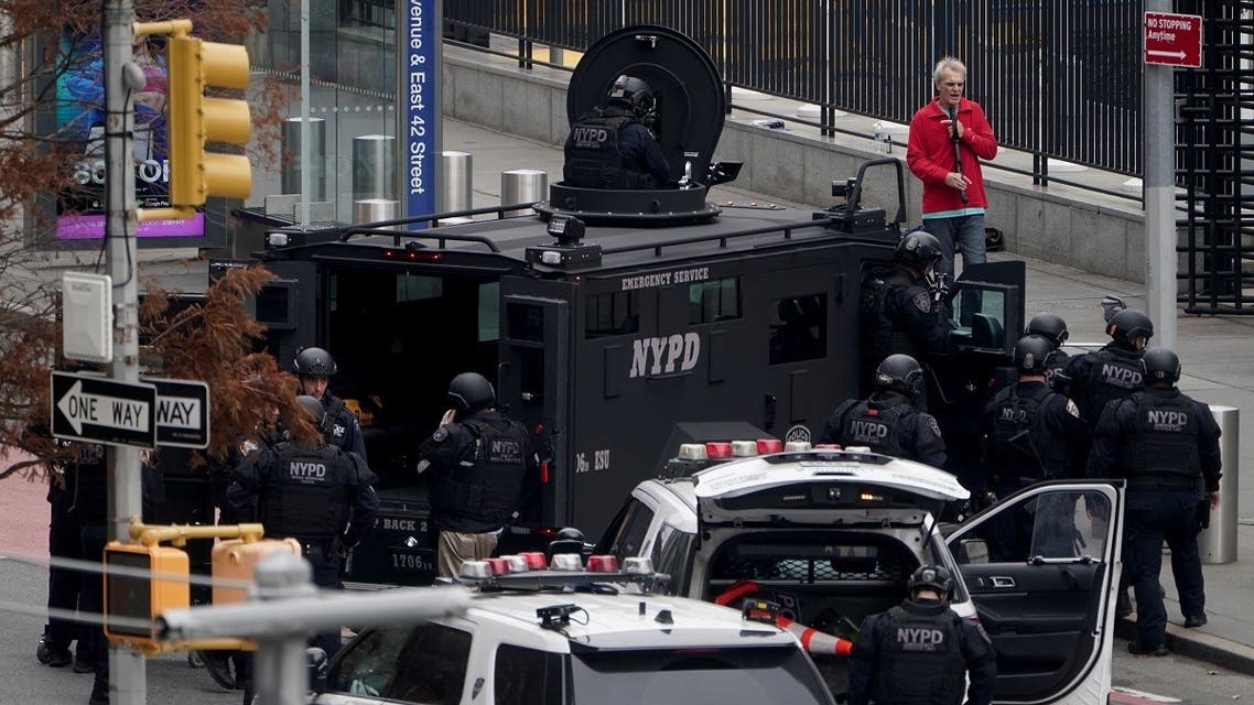 An armed man speaks with member of the NYPD outside the UN headquarters in New York City, Dec. 2, 2021. (Reuters)