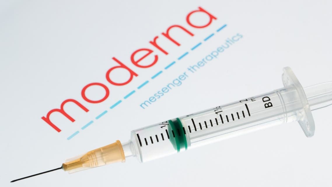 A syringe and a bottle next to the Moderna biotech company logo. (AFP)