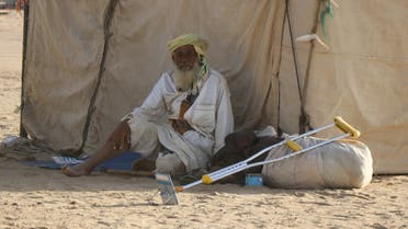 Man sits outside a tent at a camp for internally displaced people (IDPs) in Marib, Yemen November 2, 2021. REUTERS/Muhammad Fuhaid NO RESALES. NO ARCHIVES