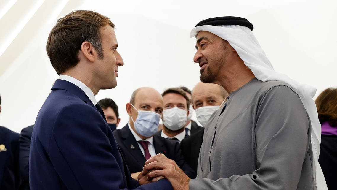 French President Emmanuel Macron (L) is greeted by Abu Dhabi’s Crown Prince Mohammed bin Zayed al-Nahyan during his tour of the French pavilion at the Dubai Expo on the first day of his Gulf tour on December 3, 2021. (Thomas Samson/AFP)