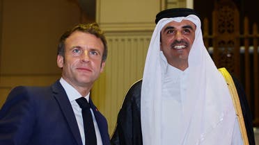Qatar's Emir Sheikh Tamim bin Hamad Al-Thani (R) receives French President Emmanuel Macron (L) at the Amiri Diwan in the capital Doha on December 3, 2021. (AFP)