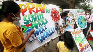Students apply finishing touches to paintings made to create an awareness against the new coronavirus Omicron variant, in Mumbai, India, on November 29, 2021. (Reuters)