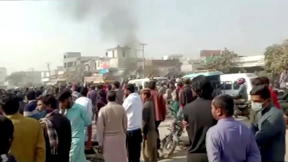 People gather after an attack on a factory in Sialkot, Pakistan December 3, 2021, in this screen grab taken from a video. (Reuters)