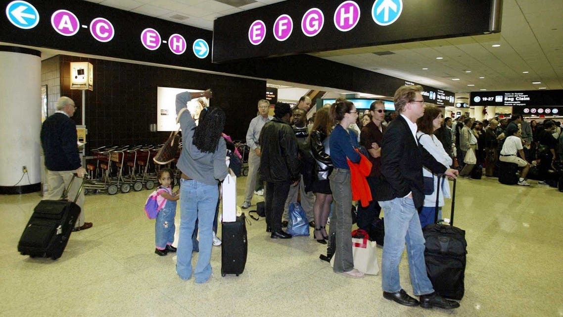 File photo of long lines form as passengers wait by the security check area at an International Terminal at Miami International Airport. (Reuters)