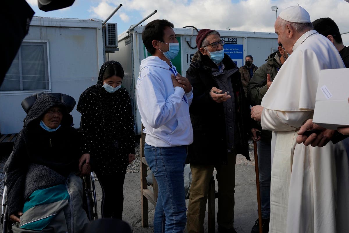 Pope Francis speaks with migrants during his visit at the Karatepe refugee camp, on the northeastern Aegean island of Lesbos, Greece, on Dec. 5, 2021. (AP)
