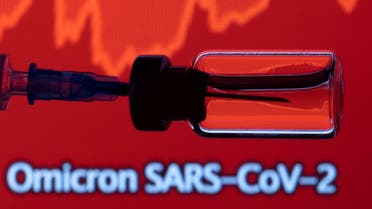 A vial and a syringe are seen in front of a displayed stock graph and words Omicron SARS-CoV-2 in this illustration taken, November 27, 2021. (Reuters)