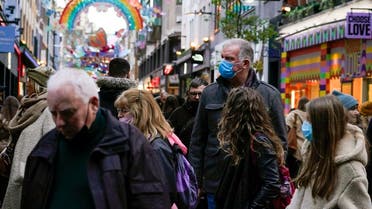 Shoppers wear masks as they walk in Carnaby Street, in London, on Dec. 4, 2021. (AP)