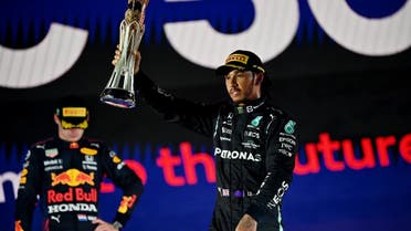 Mercedes' Lewis Hamilton celebrates with the trophy on the podium after winning the Jeddah Formula One Grand Prix. (Reuters)