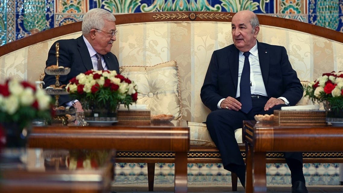 A handout picture provided by the Palestinian Authority’s press office (PPO) on December 5, 2021 shows Algerian President Abdelmadjid Tebboune (R) and his Palestinian counterpart Mahmud Abbas meeting in the capital Algiers. (Thaer Ghanaim/PPO/AFP) 