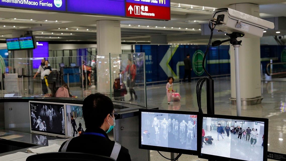 A health surveillance officer monitors passengers arriving at the Hong Kong International airport in Hong Kong. (AP)