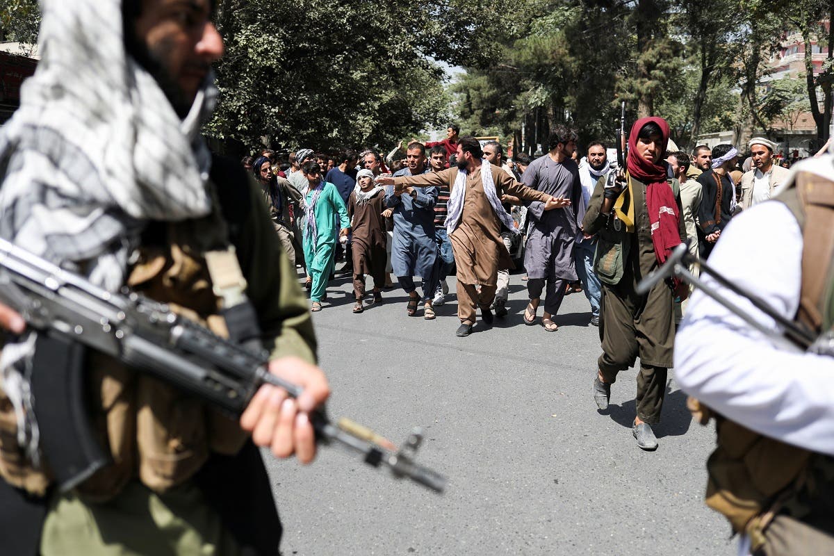 Taliban fighters in front of protesters during the anti-Pakistan protest in Kabul, Sept. 7, 2021. (Reuters)