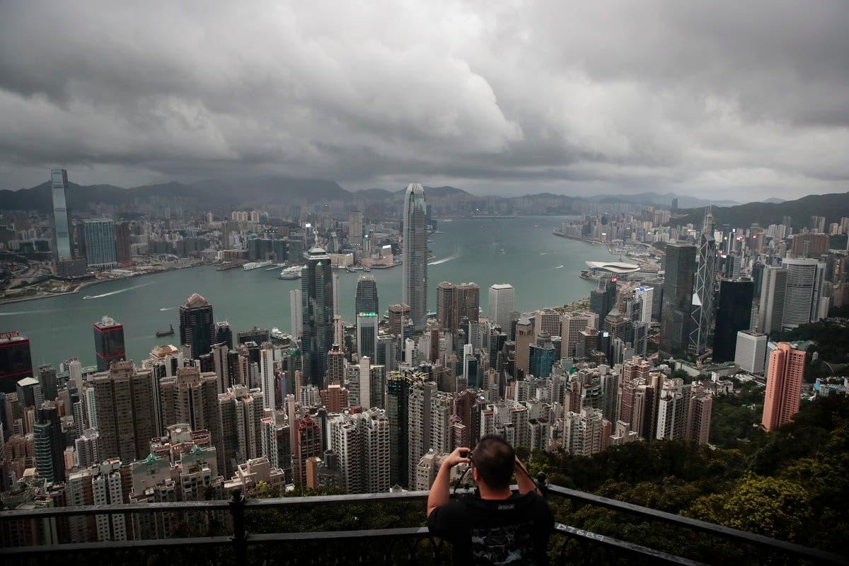 A visitor sets up his camera in the Victoria Peak area to photograph Hong Kong’s skyline.  (AP)