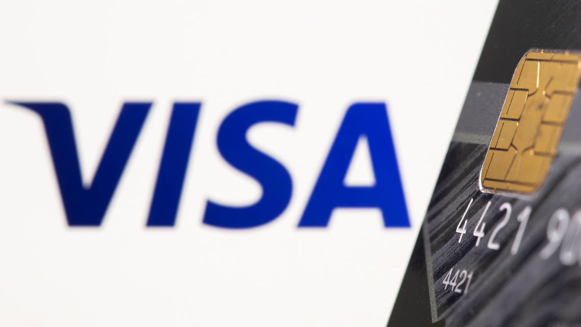 Credit card is seen in front of displayed Visa logo in this illustration taken, July 15, 2021. (Reuters)