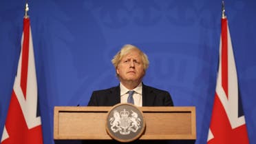 Britain's Prime Minister Boris Johnson holds a press conference for the latest Covid-19 update in the Downing Street briefing room in central London on December 8, 2021. (AFP)