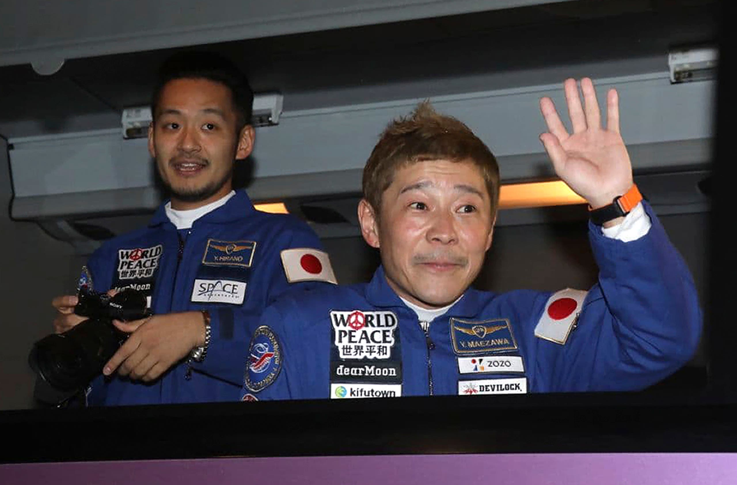 In this photo released by the Roscosmos Space Agency, spaceflight participants Yusaku Maezawa, right, and Yozo Hirano, left, of Japan, members of the main crew of the new Soyuz mission to the International Space Station (ISS) sit in a bus prior the launch at the Russian leased Baikonur cosmodrome, Kazakhstan, Wednesday, Dec. 8, 2021. (AP)