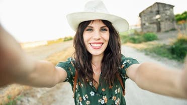 happy-woman-hat-selfie-smile-hiking-road