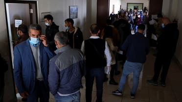 People queue at a vehicle licensing agency in Dekwaneh, Dec. 8, 2021. (Reuters)