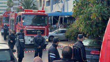 Security forces stand outside the headquarters of Tunisia's Ennahda party after a fire broke out the building in Tunis, Dec. 9, 2021. (Reuters)