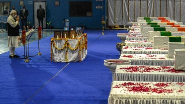 India’s PM Modi, pays his tribute in front of the coffins containing the mortal remains of Chief of Defense Staff Gen Bipin Rawat and other 12 victims during a tribute ceremony at Palam Air Force station in New Delhi on December 9, 2021. (AFP/Prakash Singh)