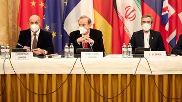 This handout photo released on December 9, 2021 shows Deputy Secretary General of the European External Action Service (EEAS) Enrique Mora (C) and Iran's chief nuclear negotiator Ali Bagheri Kani (R) attending a meeting in Vienna, Austria. (Handout/ EU delegation in Vienna/AFP)