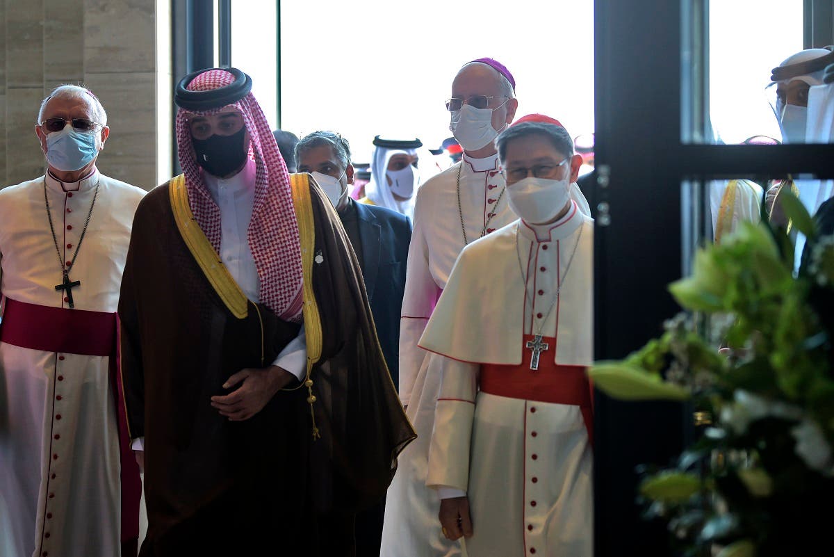Cardinal Luis Antonio Tagle (R) and sheikh Abdullah bin Hamad Al-Khalifa (C) arrive at Our Lady Arabia Cathedral ahead of its opening in Awali, south of the Bahraini capital Manama on December 9, 2021. (AFP/Mazen Mahdi)