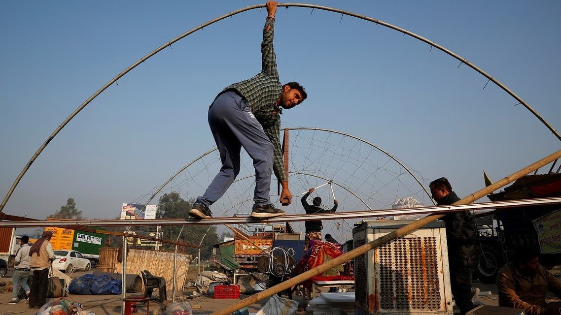 Farmers vacate a protest site, after the government agreed to their demands, including assurance to consider guaranteed prices for all produce, at the Singhu border near New Delhi, India, on December 11, 2021. (Reuters)