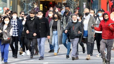 Pedestrians wearing mask walk on street, in Ankara, Turkey, on November 28, 2021. (AFP)