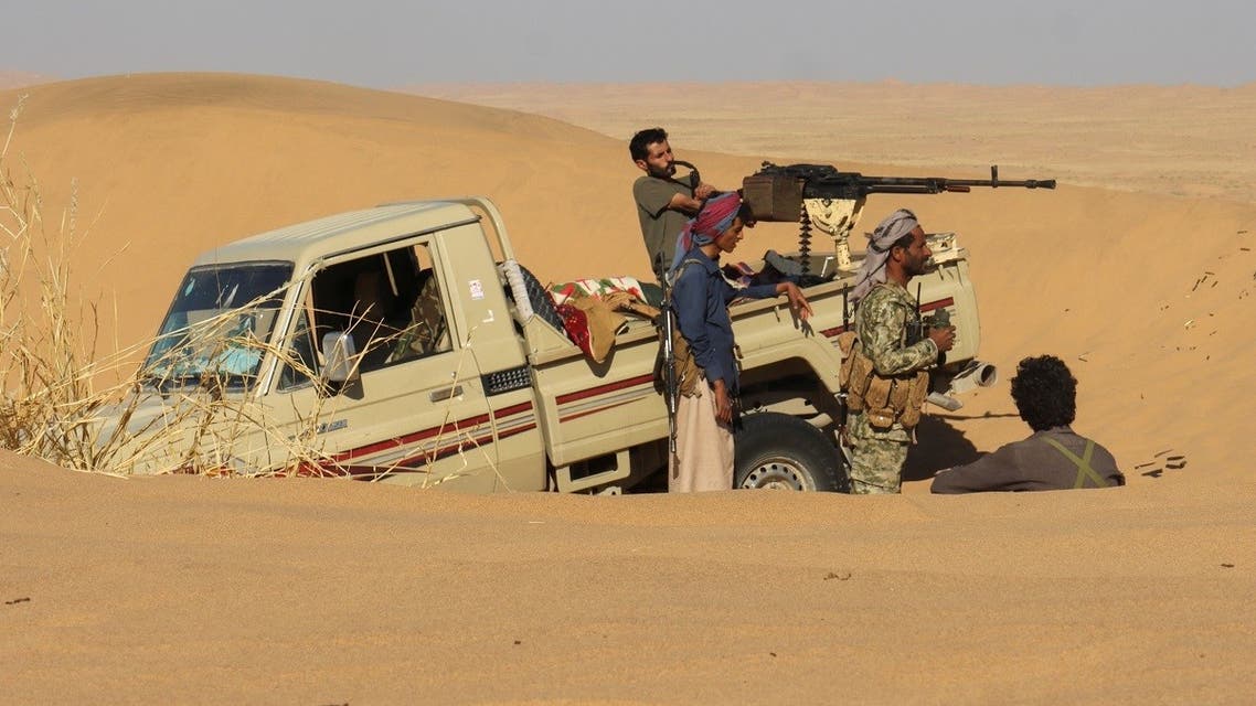 Pro-government fighters take position in a desert area southeast of Marib, Yemen December 6, 2021. (Reuters)