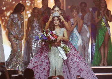Miss Universe winner Miss India Harnaaz Sandhu reacts as the Miss Universe crown is placed on her head by Outgoing Miss Universe Andrea Meza of Mexico, at the Red Sea resort of Eilat, Israel, on December 13, 2021. (Reuters)