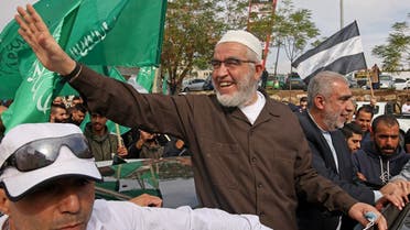 Sheikh Raed Salah (C), leader of the radical northern branch of the Islamic Movement in Israel, celebrates with supporters following his release from a jail in the mostly Arab city of Umm al-Fahm in northern Israel on December 13, 2021. (AFP/Ahmad Gharabli)