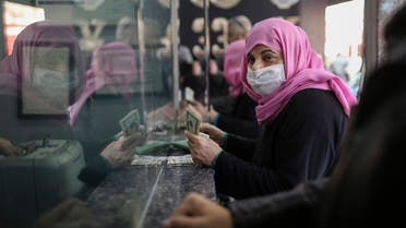 A women holds US dollars notes as she changes Turkish liras in a currency exchange office in Istanbul, Thursday, Dec. 2, 2021. (AP)