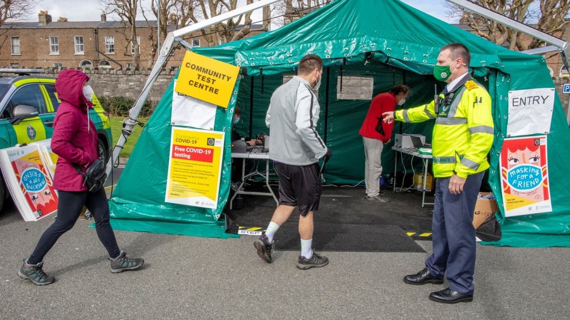 A health worker directs people at a walk-in portable testing centre for Covid-19 operated by the ambulance service in Dublin, Ireland on March 25, 2021. (AFP)
