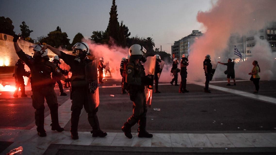 Police use tear gas to disperse thousands of protesters in Athens' Syntagma Square opposing the government's plan for mandatory Covid-19 vaccination for health workers, in Athens on August 29, 2021. (AFP)