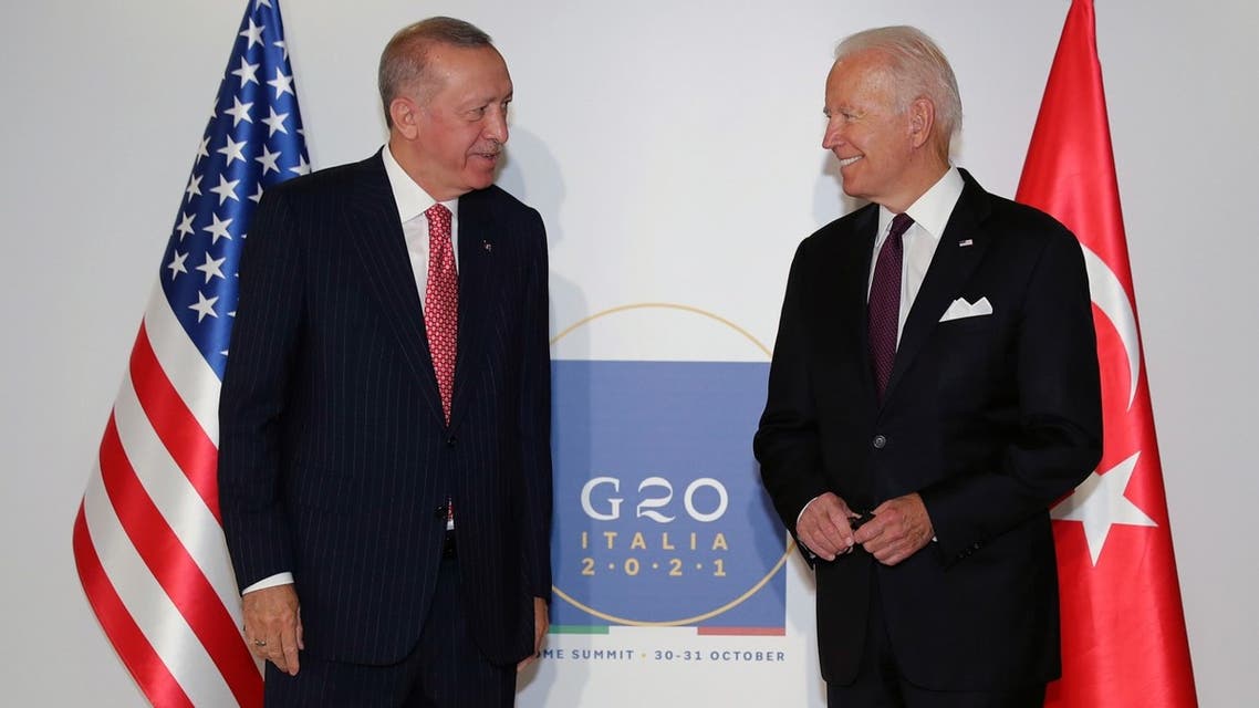 This handout photograph taken and released on October 31, 2021 by the Turkish Presidential Press Service shows Turkey's President Recep Tayyip Erdogan (L) and US President Joe Biden (R) posing before their meeting during the G20 Summit at the Roma Convention Center La Nuvola. (AFP)