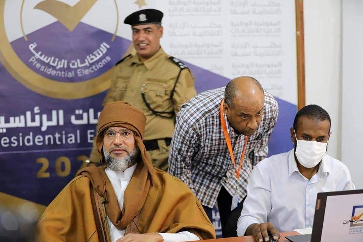  Saif al-Islam Gaddafi, left, the son and one-time heir apparent of late Libyan ruler Muammar Gaddafi registering his candidacy for the country's presidential elections next month in Sabha, Libya, on Nov. 14, 2021. (AP)