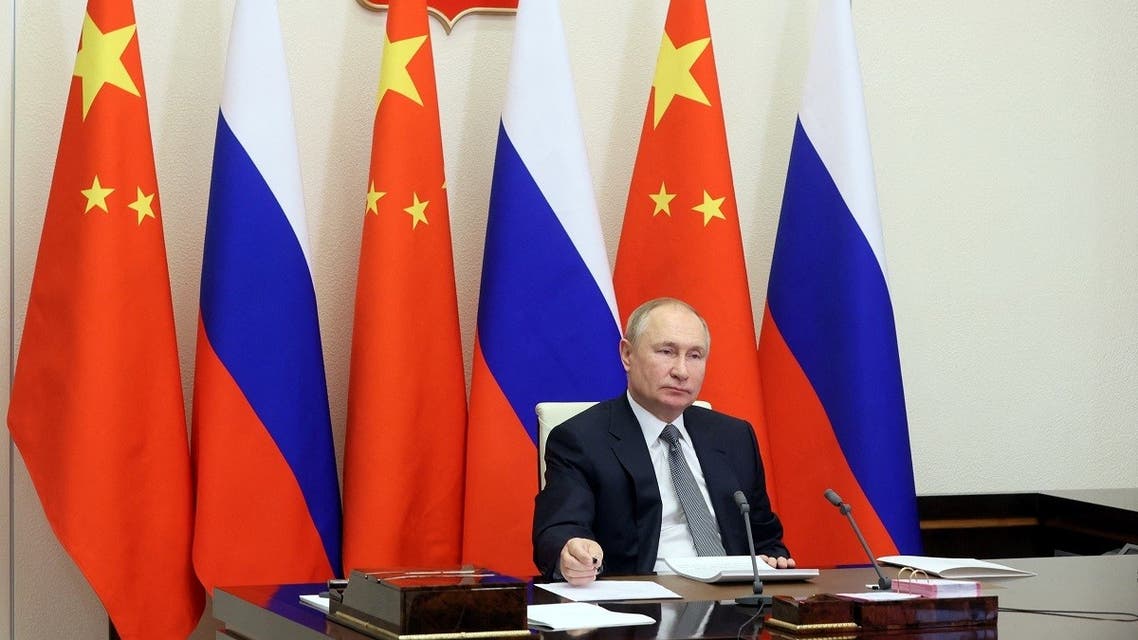 Russian President Vladimir Putin holds talks with Chinese President Xi Jinping via a video link at his residence outside Moscow, Russia December 15, 2021. (Sputnik/Mikhail Metzel/Pool via Reuters)