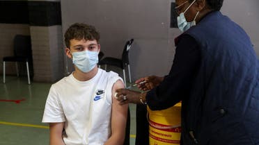 A healthcare worker administers a dose of the Pfizer coronavirus vaccine to a teenager, amidst the spread of the Omicron variant, in Johannesburg, South Africa, on December 9, 2020. (Reuters)