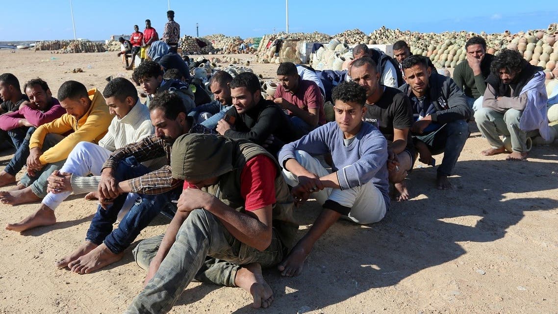 Migrants rescued by Tunisia’s national guard during an attempted crossing of the Mediterranean by boat, rest on the beach at the port of el-Ketef in Ben Guerdane in southern Tunisia near the border with Libya, on December 15, 2021. (AFP/Fathi Nasri)