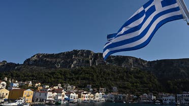 This picture shows a view of the tiny Greek island of Kastellorizo (Megisti) with a Greek flag, in the Dodecanese, the furthest south eastern Greek Island, two kilometers from the Turkish mainland, on August 28, 2020. (AFP)