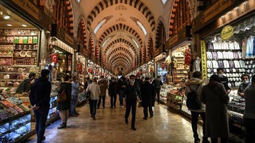 Pedestrians and customers walk inside The Spice Bazaar in Istanbul, on March 22, 2021. (AFP)