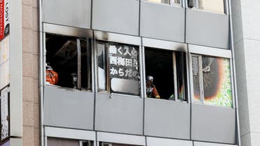 Firefighters work at the scene, where twenty-seven people were feared dead after a blaze at a building in Osaka, on December 17, 2021. (Photo by JIJI PRESS / AFP) / JAPAN OUT