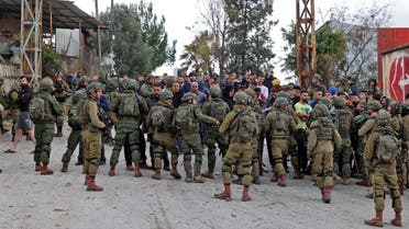 Palestinian residents of the West Bank village of Burqah confront Israeli soldiers on December 17, 2021, after reported attacks by Israeli settlers on the village. (AFP/Jaafar Ashtiyeh)