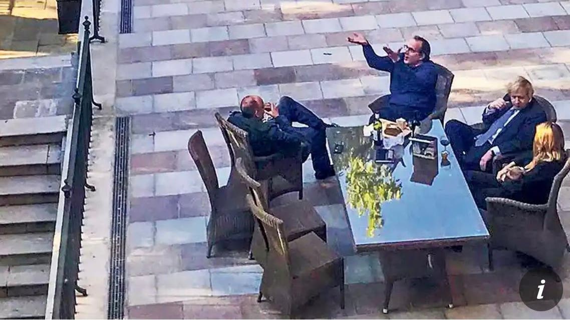 A photograph showing British Prime Minister Boris Johnson and more than a dozen other people drinking wine in the garden of his Downing Street residence during a lockdown last year. (Twitter)