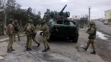 This handout picture taken and released by Ukraine's Security Service on April 14, 2021 shows Security Service special troops servicemen standing past a tank during a large-scale anti-terrorism exercises in Kherson region of the country.  (AFP)